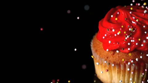 Sprinkles falling onto a cupcake in slow motion Stock Video