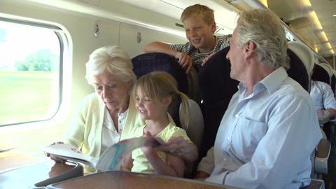 Grandparents taking young grandson and granddaughter on train trip