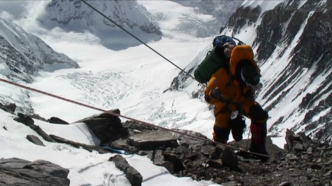 MT. EVEREST - CIRCA 2010: Climber ascending rocky patch on ropes