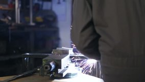 A man welding in his workshop. Close up. High definition video.