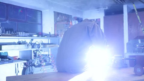 A man welding in his workshop. High definition video.