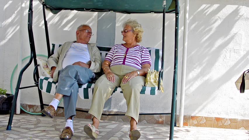 Senior couple sitting together talking, resting and having fun Stock Video.