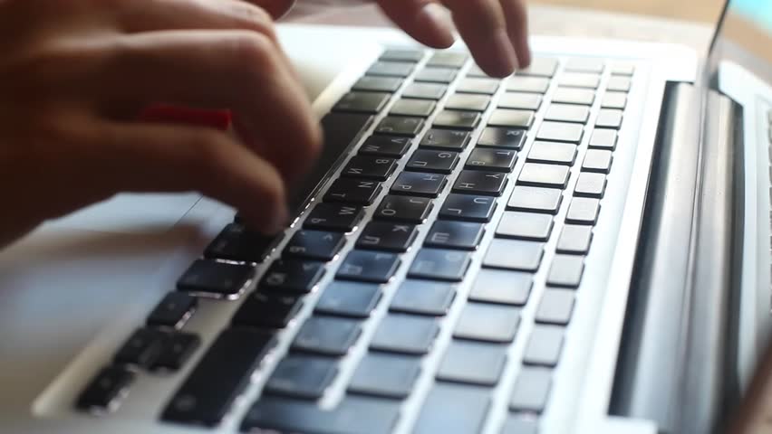 Close up of woman's fingers typing on laptop keyboard (HD)