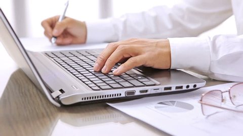 Contemporary man with pen / HD stock footage of business person working with laptop computer and ballpoint pen

