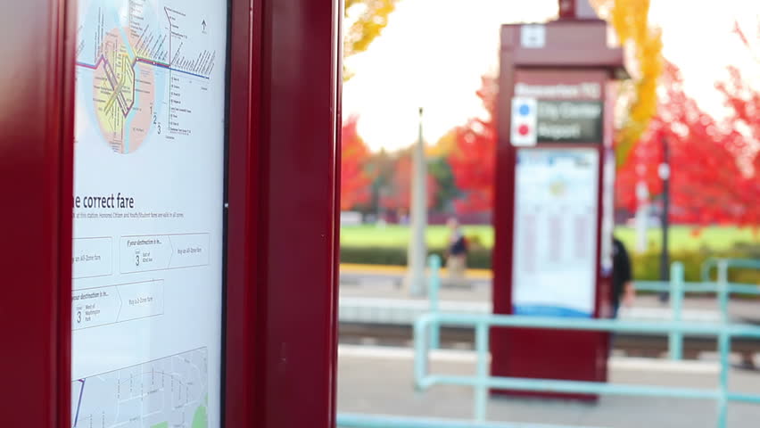 A young man and woman look over a map to try and determine where they need to go on the train
