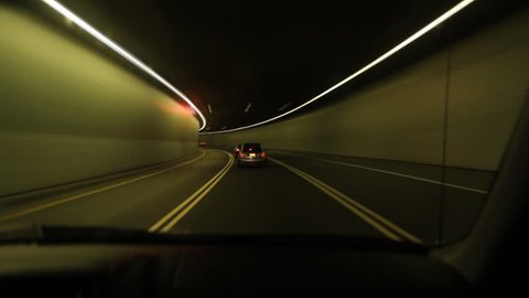 Montreal timelapse tunnel.
Driving through a tunnel lit with green and orange light. Timelapse effect. Montreal, Quebec, Canada. 
