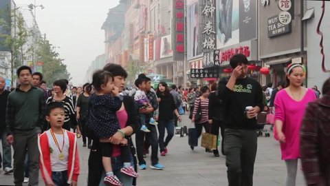 BEIJING, CHINA - OCTOBER 6, 2013: During holiday, people roam Wangfujing Pedestrian Street, Beijing, China