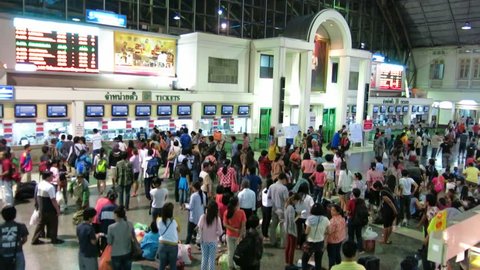 Bangkok, Thailand – October 17, 2013: Thais and tourists  stand  to show respect when the national anthem is played, Hua Lamphong Railway Station. It is played twice a day in many public places. 