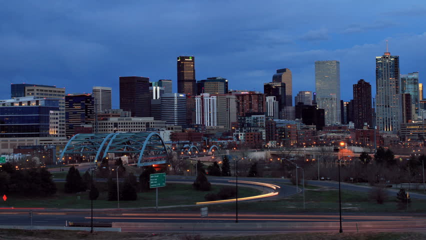 Denver skyline at dusk, with fast moving traffic on the interstate. HD 1080p