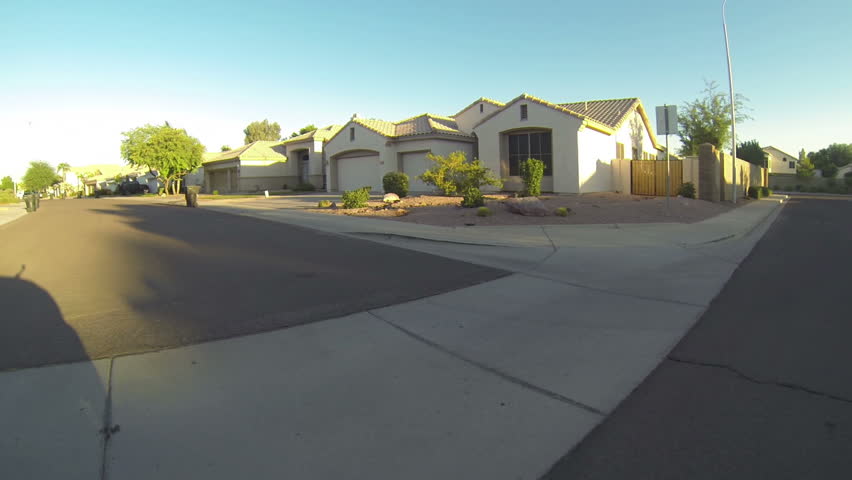 Driving in a typical Arizona neighborhood on an early morning. pov.
