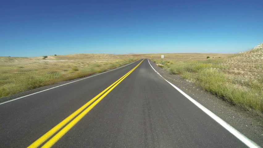 Fast perspective of a desolate desert road. pov.