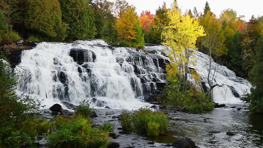 Loop features whitewater cascading over boulders with brilliantly colorful fall foliage. Shot at Bond Falls, a waterfall in Michigan