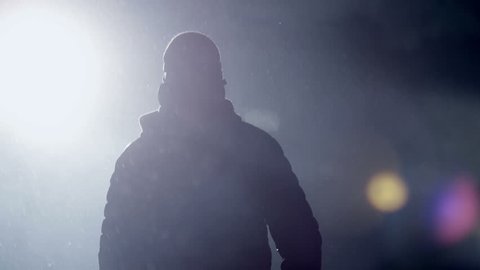 Man goes through the smoke at night