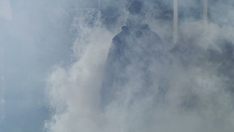 Man goes through the smoke at night