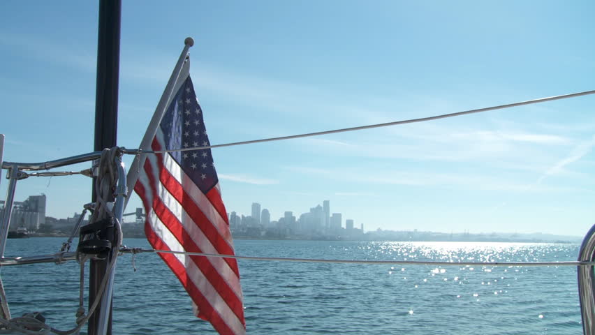 Stars and Stripes in foreground on a yacht sailing on the Puget Sound in