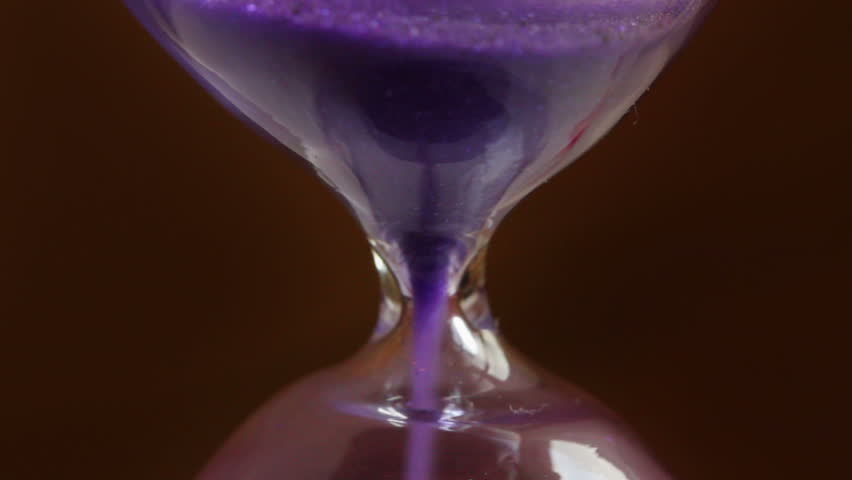countdown - running sand in the hourglass closeup