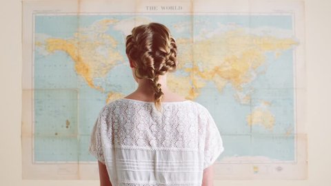 Tourist woman looking at world map planning travel adventure Stock Video