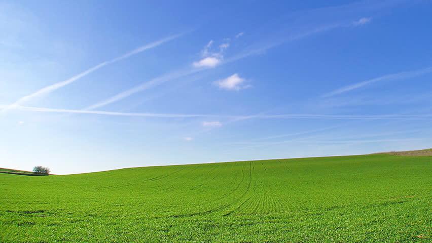 Time lapse, white clouds passing over green hills (windows xp background style