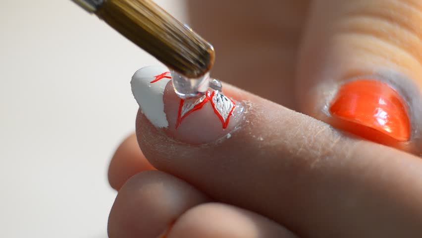 Applying nail polish on art painted manicure - Stock Video. Nail polish on