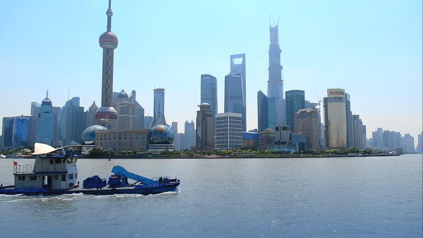 Shanghai skyline of Pudong, seen from the Bund, with boat