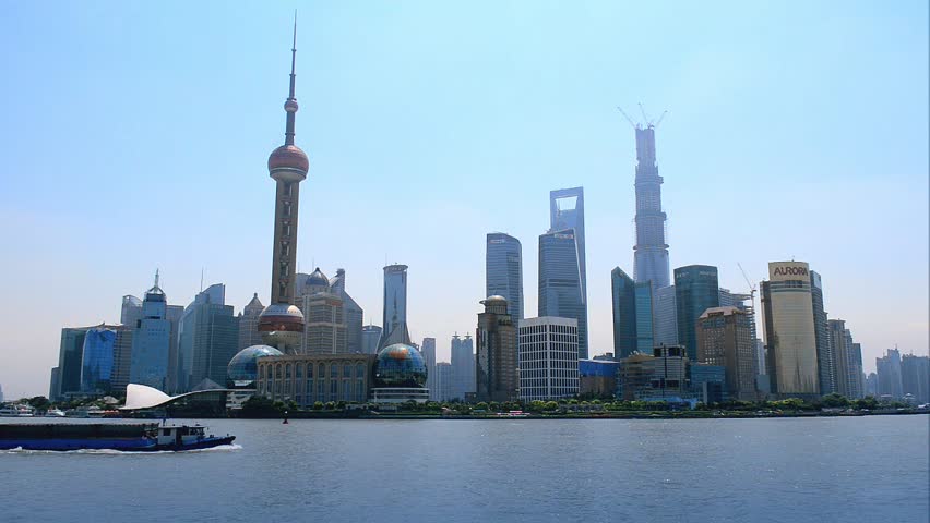 Shanghai skyline of Pudong, seen from the Bund, with boat