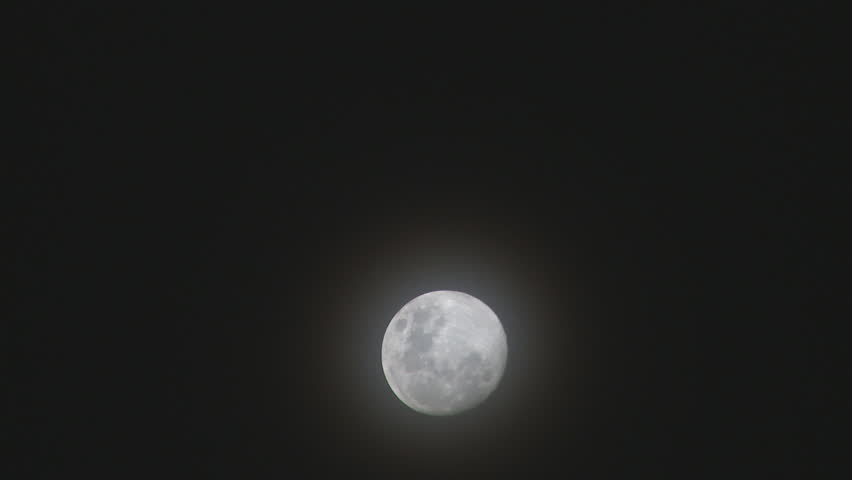 A full moon time lapse as it passes through light cloud.