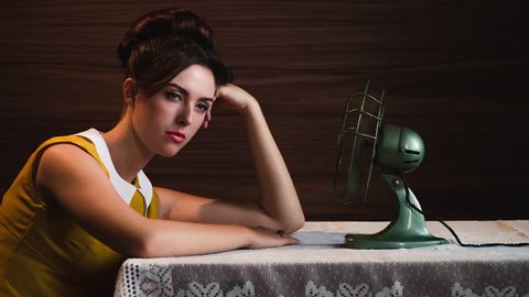 Vintage styled portrait attractive young woman with 60's fan - available in 4k : vidéo de stock