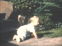 1960s vintage, archival home video of father helping toddler son learn to walk in Seattle, Washington neighborhood.