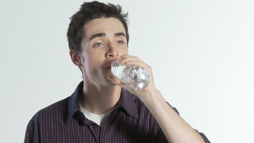 Close up of guy taking a long drink of refreshing bottled water.