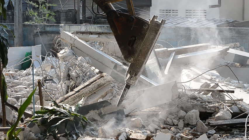 machine hydraulic hammer destroy old building in construction site