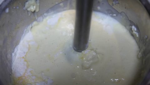 Baker mixed flour with hand mixer machine