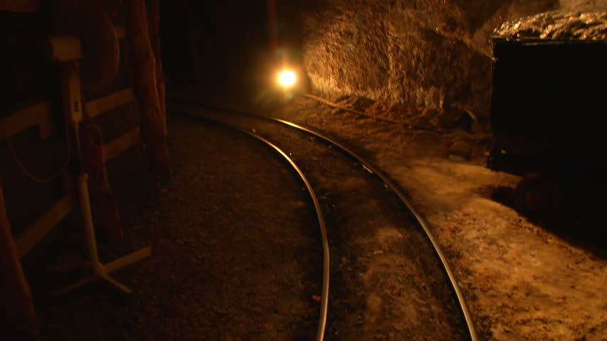 Mine tunnel with rails and light