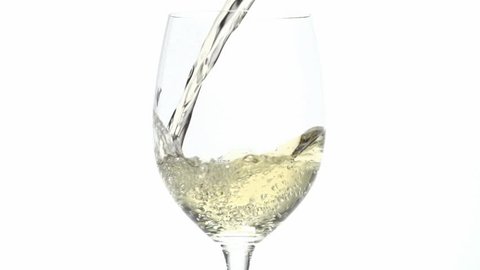 Slow motion close up of white wine pouring into a glass. Shot at 240 frames per second. Shot can be sped up to play at normal speed.