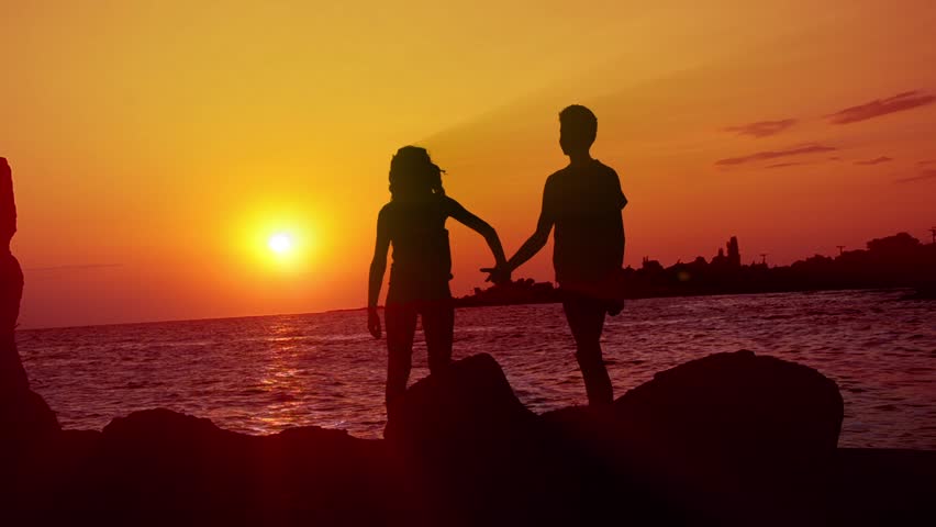 HD: Romantic Walk - Stock Video. HD1080: Boy and girl as a silhouette are taking