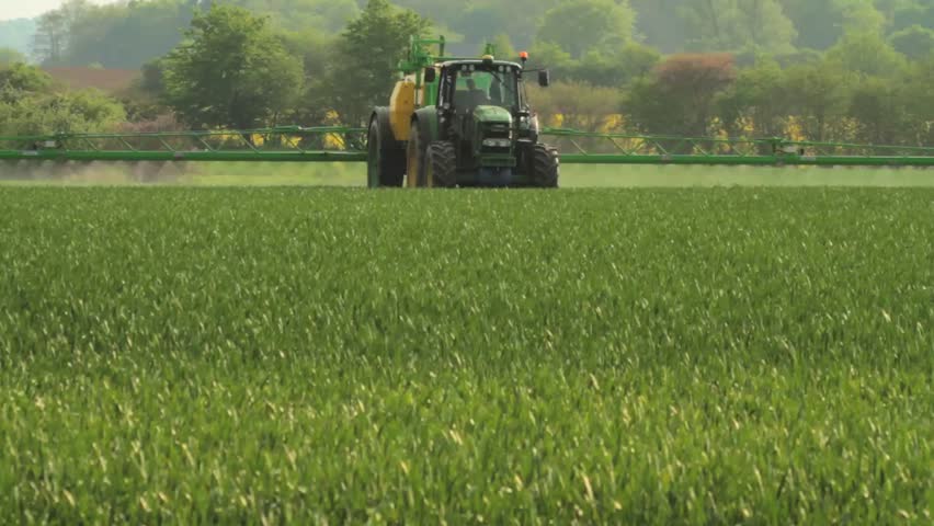 Spreading Pesticides on a Corn Field