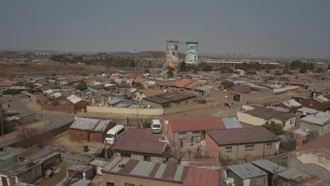 Aerial footage of Soweto township with Orlando Towers landmark in the background.