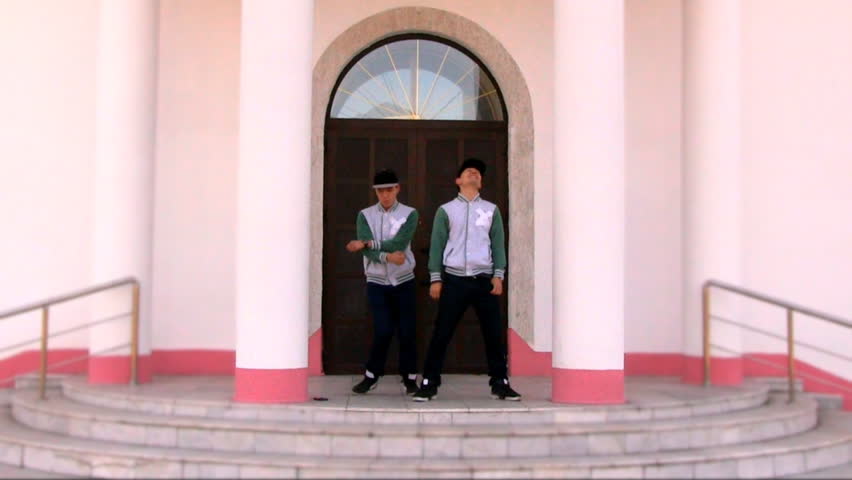 two guys dancing around the house
