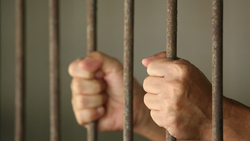 Hands of Prisoner gripping in and out on rusty prison bars | Shutterstock HD Video #4948805