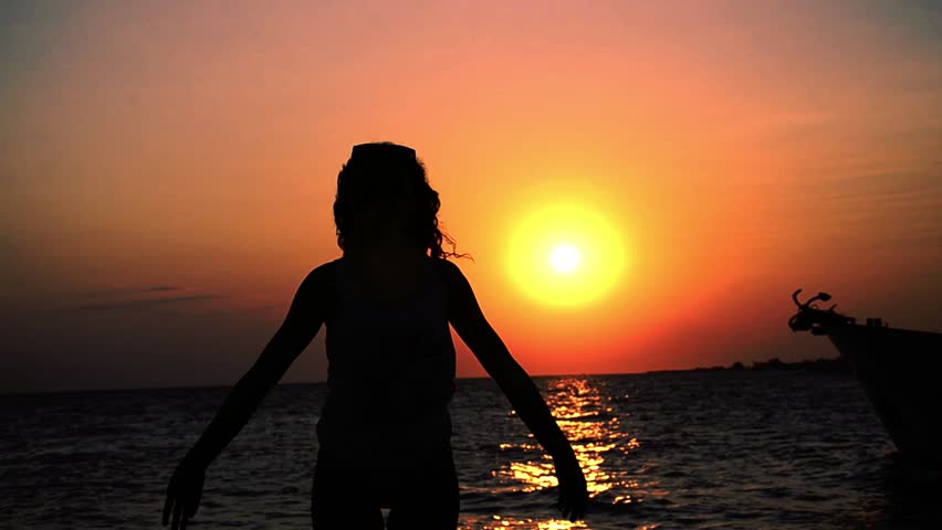 Yoga At The Sunset - Stock Video. Silhouette of a teen practicing yoga at the