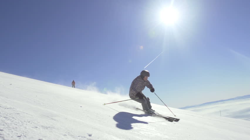 Slow Motion Of A Professional Skier Skiing Downhill With Sun Shining