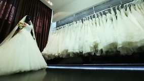 Beautiful dresses in wedding salon. Dolly shot.