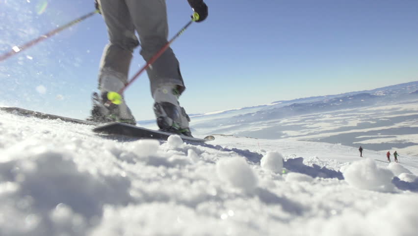 Slow Motion Of Back-Country Skier Skiing Down The Snowy Slope With Spectacular