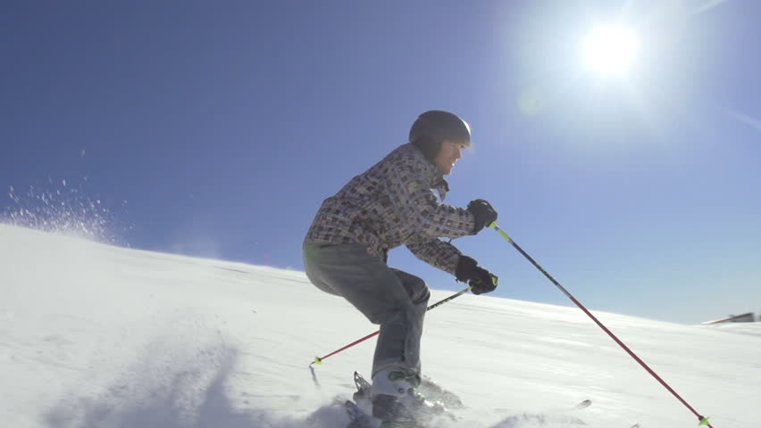 Slow Motion Of Back-Country Skier Skiing Down The Snowy Slope On A Sunny Winter
