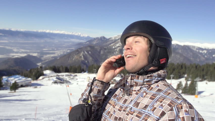 Slow Motion Of Skier Taking A Break And Making Telephone Call On The Snowy