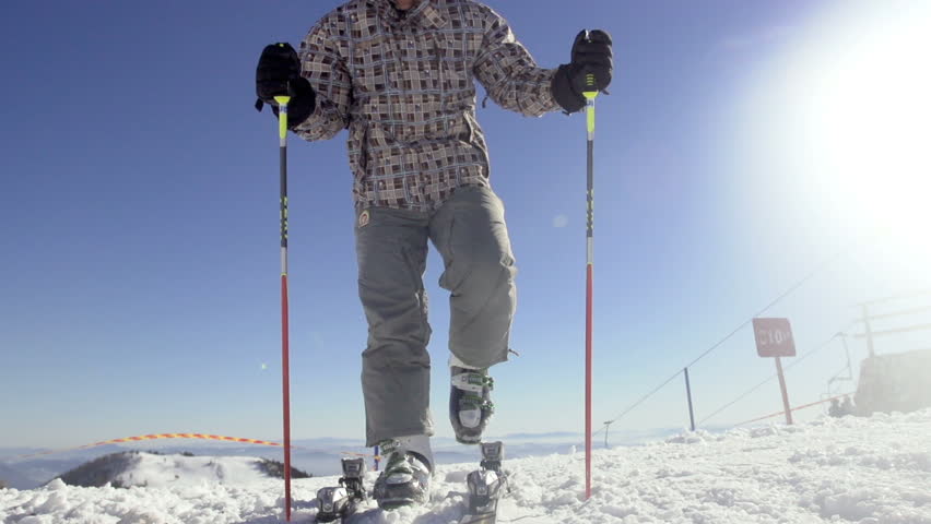 Slow Motion Of Cross-Country Skier Attaching Ski Boots To Start Skiing On A