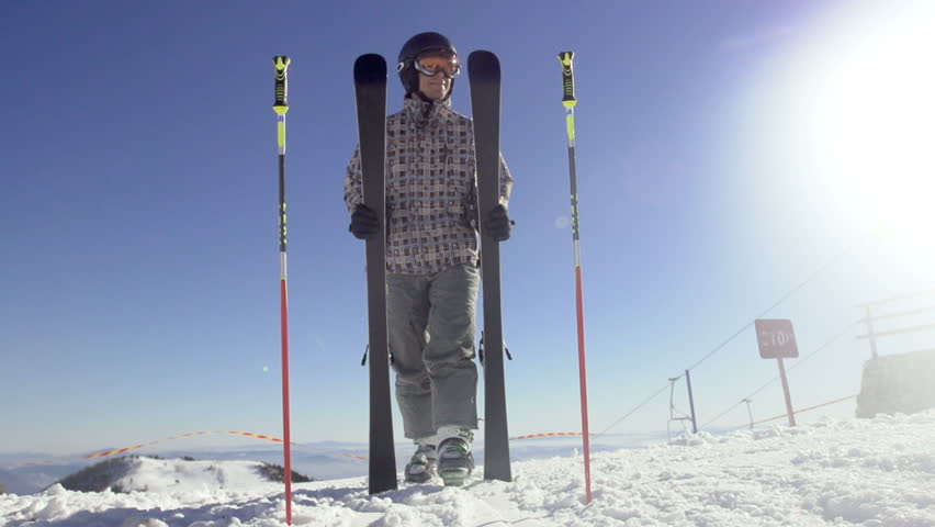 Slow Motion Of Skier Preparing Carving Skies To Start Skiing On A Sunny Winter