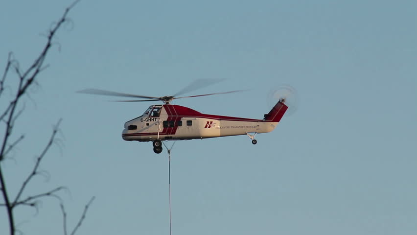 MISSISSAUGA, CANADA - OCT 20 2013: Helicopter lifting large air conditioning /