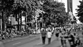 Time lapse clip of marathon runners passing by in Black and white 