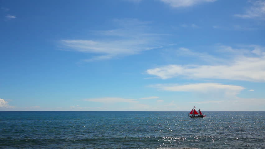 ship with red sails floating on sea