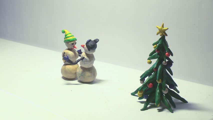 Two snowmen are waltzing at Christmas tree. Claymation